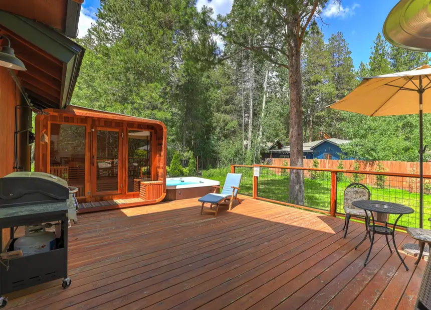 The deck of the house, looking into the pines